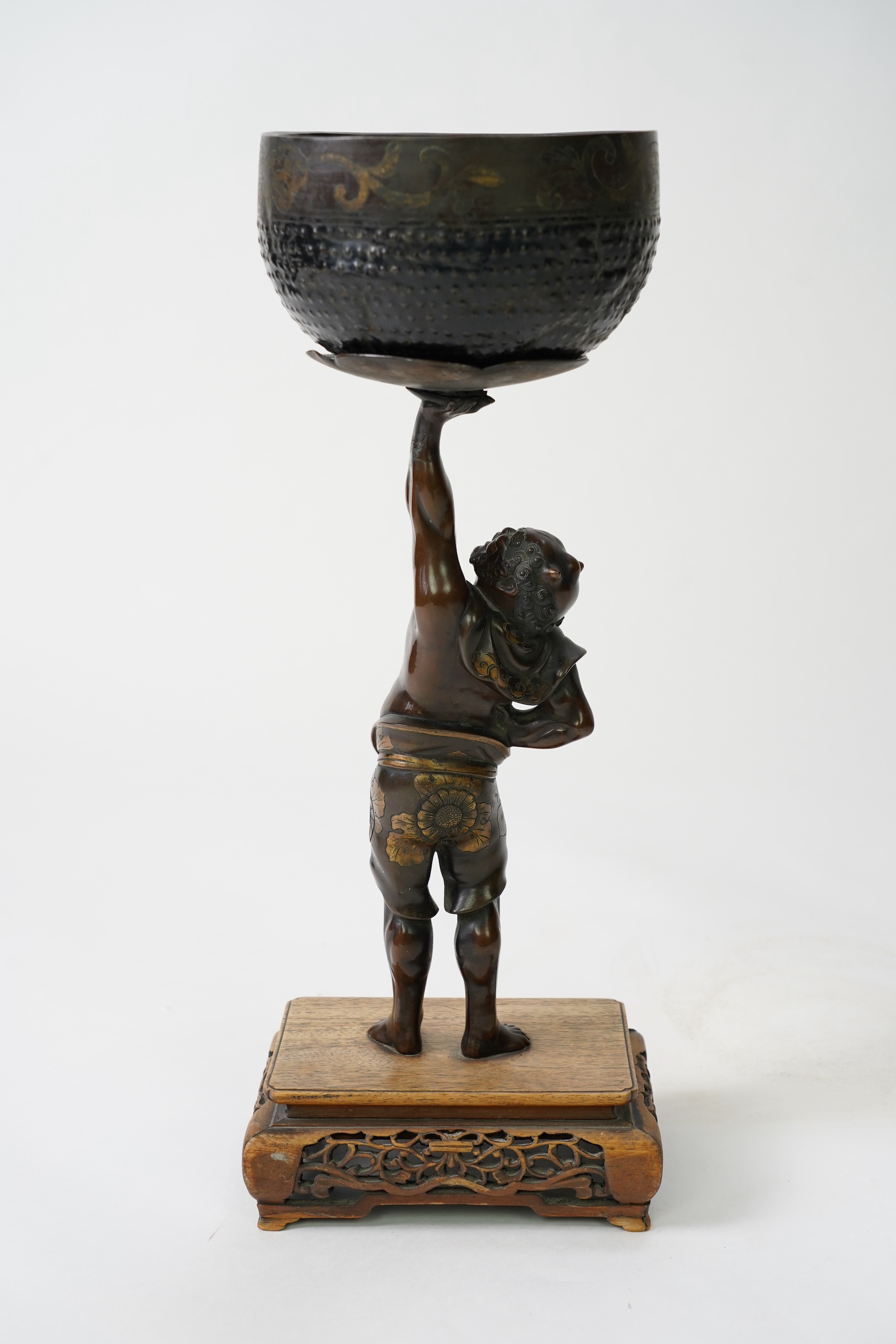 A Japanese bronze figure of an Oni holding a temple bell aloft, Meiji period, in Miyao style